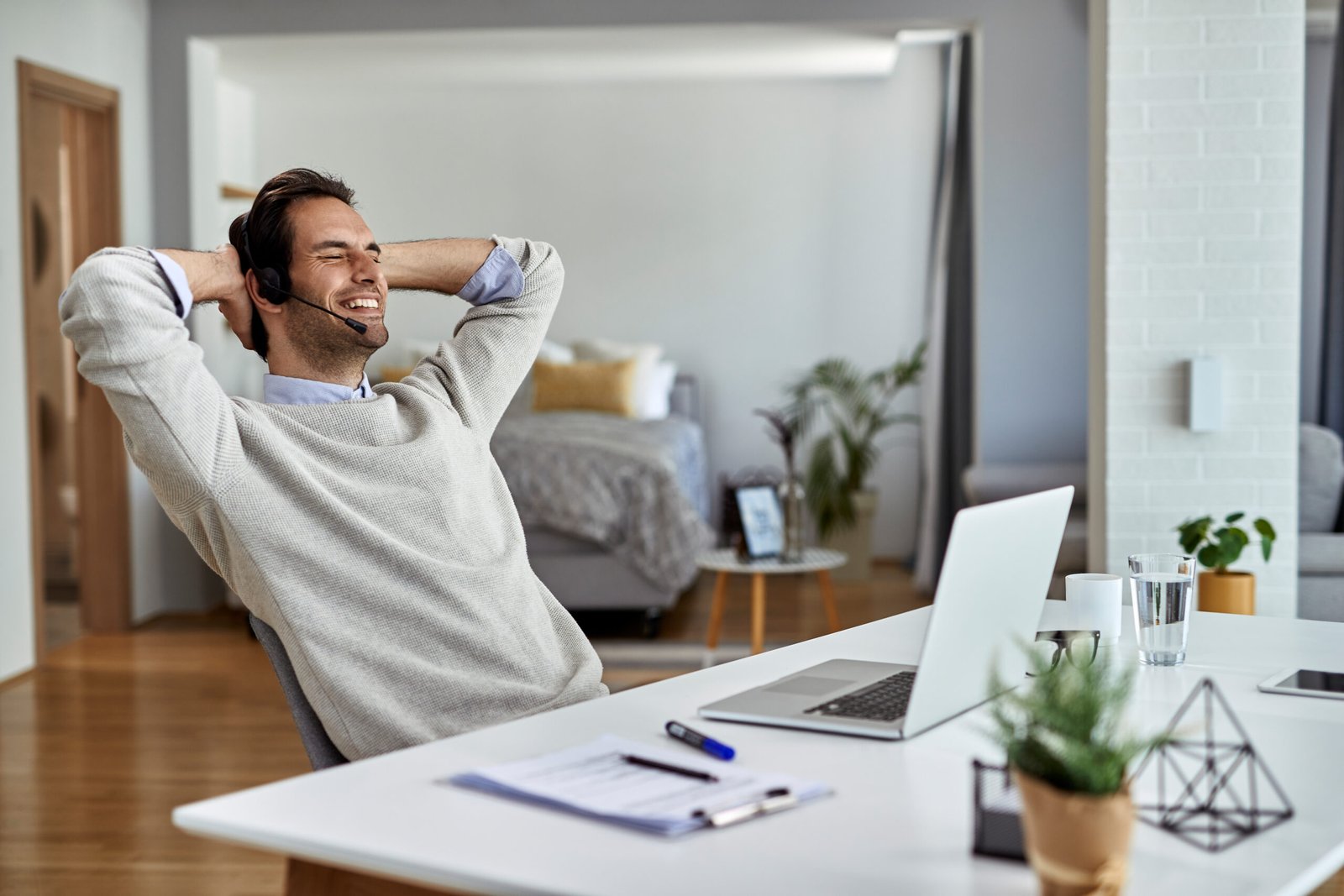 Happy businessman relaxing with eyes closed after working on lap